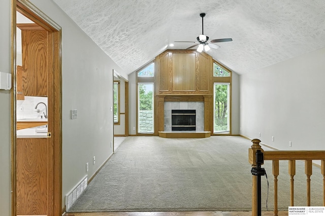 1422 N 155th Ave, Omaha, NE 68154 - unfurnished living room with a ceiling fan, a textured ceiling, healthy amount of natural light, lofted ceiling, and light carpet