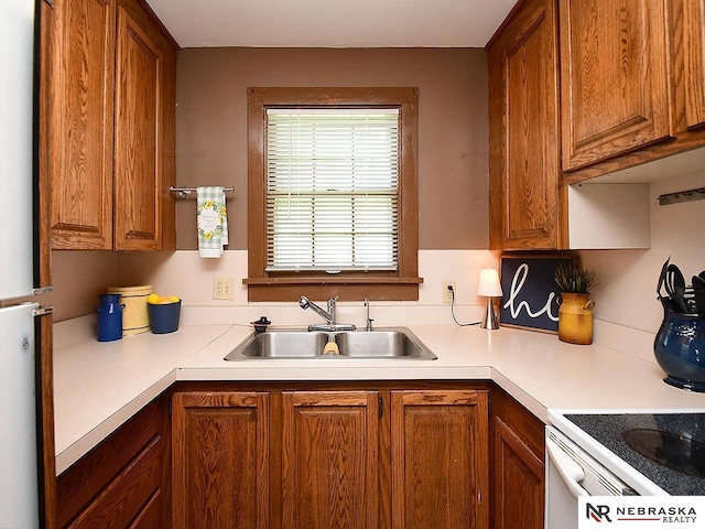 95 S Irving St, Fremont, NE 68025 - kitchen with brown cabinetry, light countertops, and freestanding refrigerator