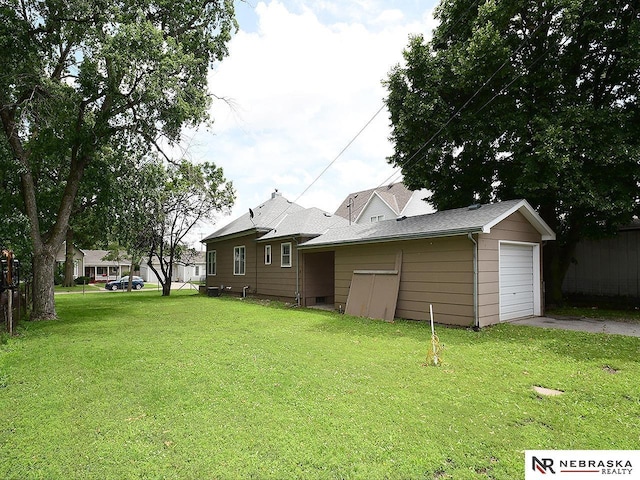 95 S Irving St, Fremont, NE 68025 - view of side of property featuring driveway, a lawn, and a garage