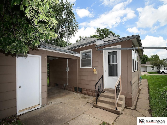 95 S Irving St, Fremont, NE 68025 - rear view of house featuring entry steps, a patio, crawl space, and roof with shingles