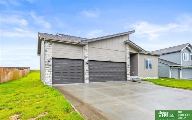 13512 S 55th St, Papillion, NE 68133 - mid-century home with stone siding, driveway, and a garage