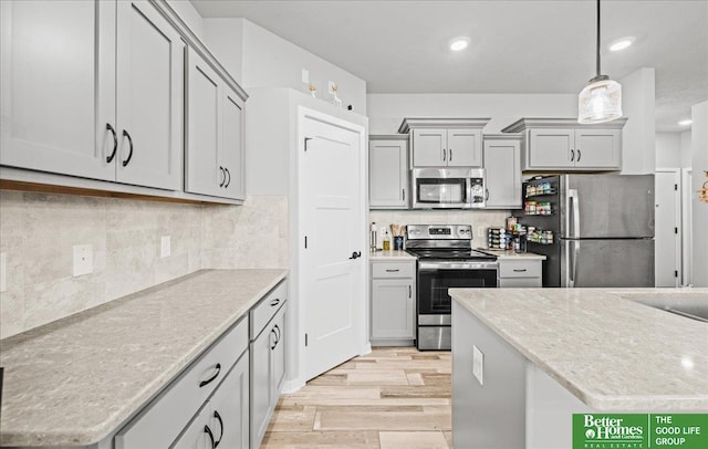 13512 S 55th St, Papillion, NE 68133 - kitchen with appliances with stainless steel finishes, light wood-style flooring, gray cabinetry, decorative light fixtures, and backsplash