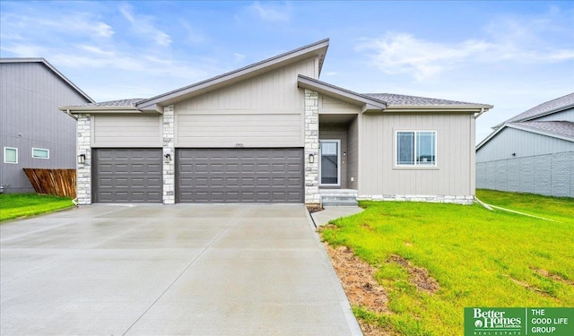 13512 S 55th St, Papillion, NE 68133 - view of front of property with a garage, driveway, and stone siding