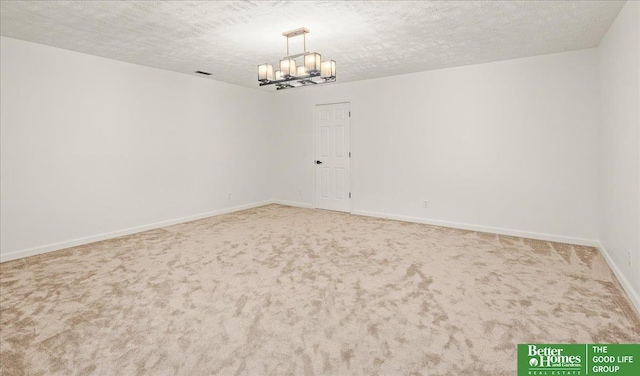 13512 S 55th St, Papillion, NE 68133 - empty room with a chandelier, carpet flooring, and a textured ceiling