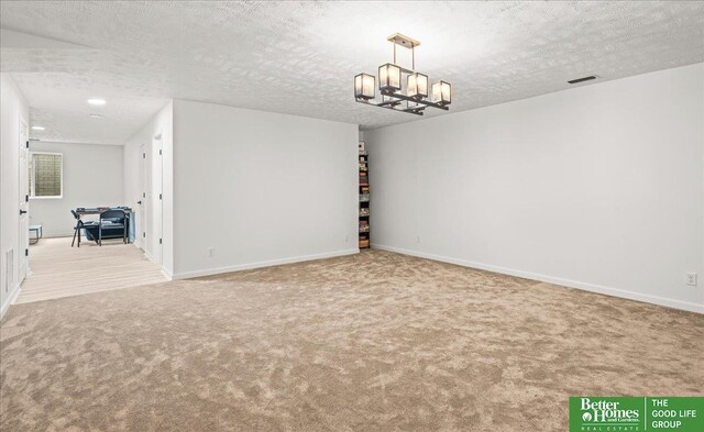 13512 S 55th St, Papillion, NE 68133 - spare room featuring carpet flooring, a textured ceiling, and a chandelier
