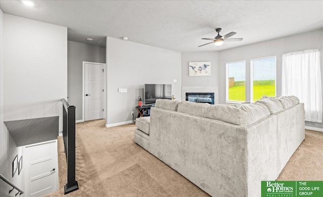 13512 S 55th St, Papillion, NE 68133 - living area with light colored carpet, a ceiling fan, and a glass covered fireplace
