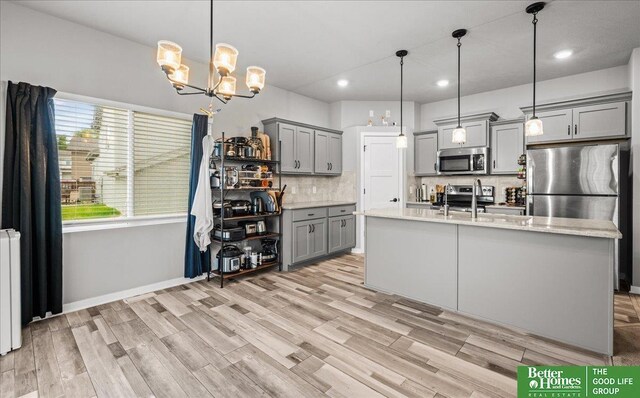 13512 S 55th St, Papillion, NE 68133 - kitchen with appliances with stainless steel finishes, gray cabinetry, tasteful backsplash, recessed lighting, and a chandelier