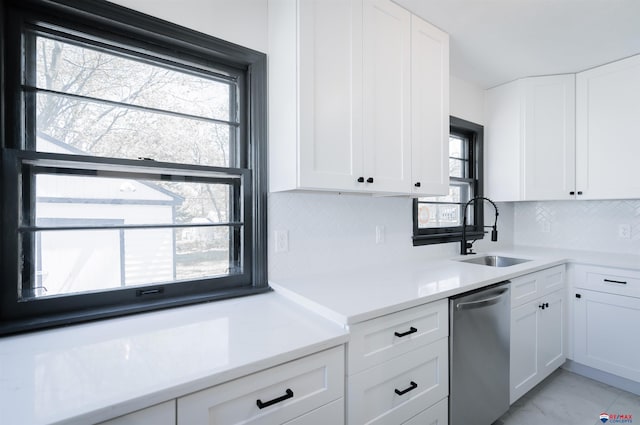 3018 S 42nd St, Lincoln, NE 68506 - kitchen with dishwasher, white cabinets, and backsplash