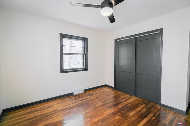 3018 S 42nd St, Lincoln, NE 68506 - unfurnished bedroom with dark wood-style floors, a closet, and a ceiling fan