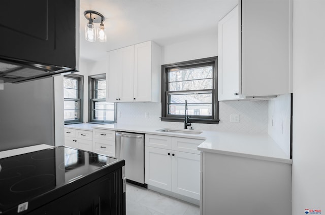 3018 S 42nd St, Lincoln, NE 68506 - kitchen with stainless steel dishwasher, black range with electric stovetop, tasteful backsplash, and white cabinetry