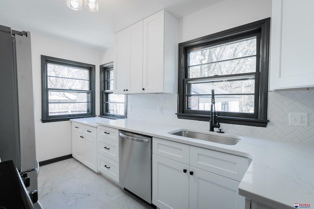 3018 S 42nd St, Lincoln, NE 68506 - kitchen featuring dishwasher, backsplash, freestanding refrigerator, light marble finish floors, and white cabinetry