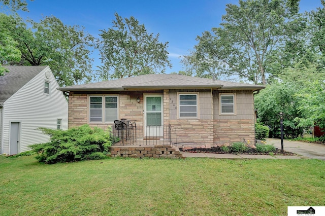 2340 S 36th St, Lincoln, NE 68506 - view of front of property featuring stone siding, a front lawn, and roof with shingles