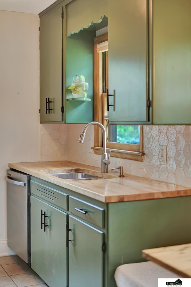 2340 S 36th St, Lincoln, NE 68506 - kitchen featuring green cabinetry, stainless steel dishwasher, tasteful backsplash, and wooden counters