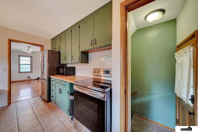 2340 S 36th St, Lincoln, NE 68506 - kitchen with stainless steel appliances, green cabinetry, tasteful backsplash, light tile patterned floors, and ceiling fan