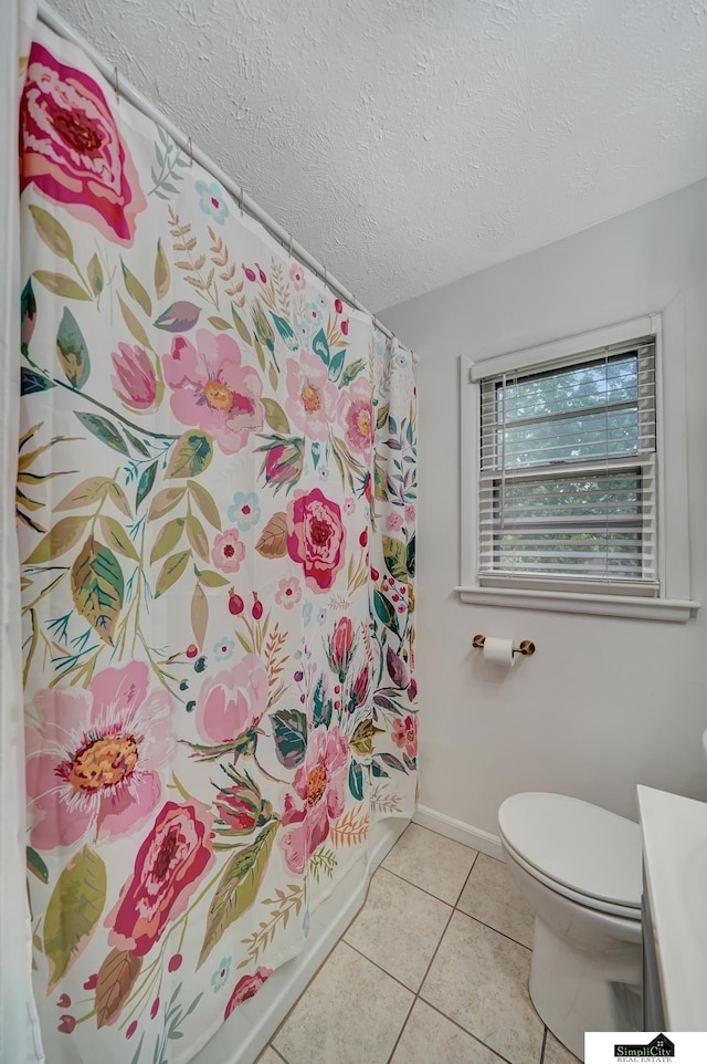 2340 S 36th St, Lincoln, NE 68506 - full bathroom with vanity, tile patterned floors, and a textured ceiling