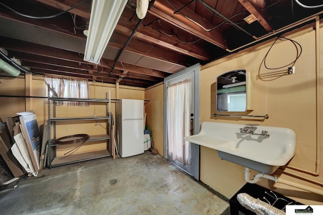2340 S 36th St, Lincoln, NE 68506 - basement featuring freestanding refrigerator and a sink