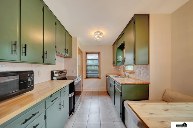 2340 S 36th St, Lincoln, NE 68506 - kitchen featuring appliances with stainless steel finishes, green cabinets, wooden counters, and tasteful backsplash
