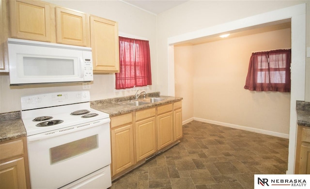 1548 E 5th St, Fremont, NE 68025 - kitchen with white appliances, light brown cabinetry, and stone finish floors