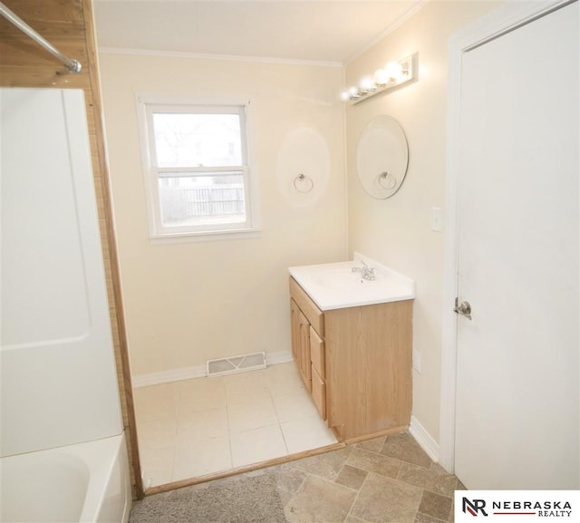 1548 E 5th St, Fremont, NE 68025 - bathroom with vanity, crown molding, tub / shower combination, and tile patterned floors