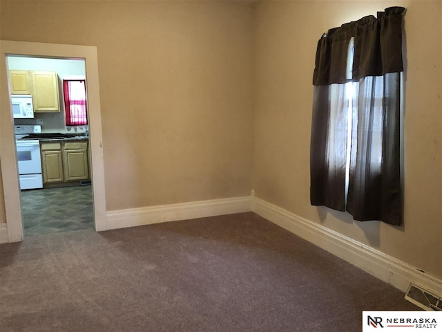 1548 E 5th St, Fremont, NE 68025 - spare room with dark carpet and baseboards