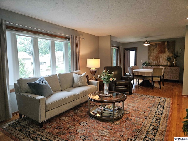 11821 Shirley St, Omaha, NE 68144 - living room featuring a textured ceiling, ceiling fan, and wood finished floors