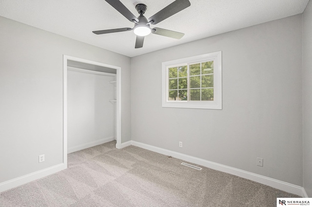 1409 Nelson Ln, Fremont, NE 68025 - unfurnished bedroom with carpet floors, a closet, and ceiling fan