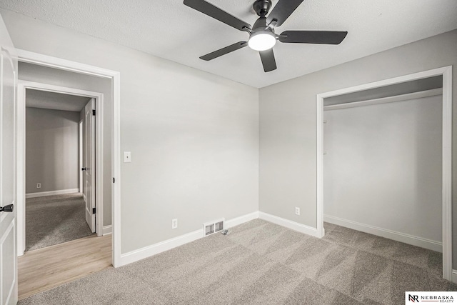 1409 Nelson Ln, Fremont, NE 68025 - unfurnished bedroom featuring carpet floors, ceiling fan, a closet, and a textured ceiling
