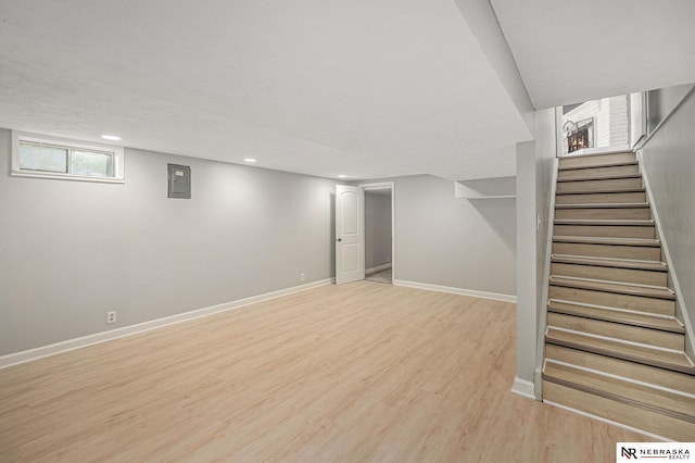 1409 Nelson Ln, Fremont, NE 68025 - below grade area featuring stairs, light wood-type flooring, electric panel, and recessed lighting