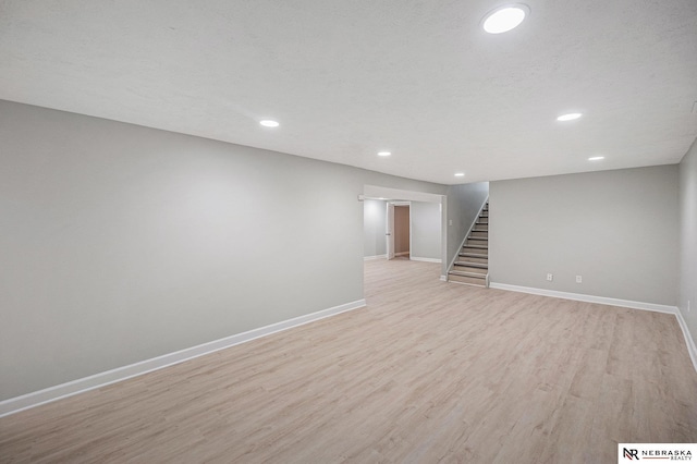 1409 Nelson Ln, Fremont, NE 68025 - finished basement with stairway, light wood finished floors, and recessed lighting