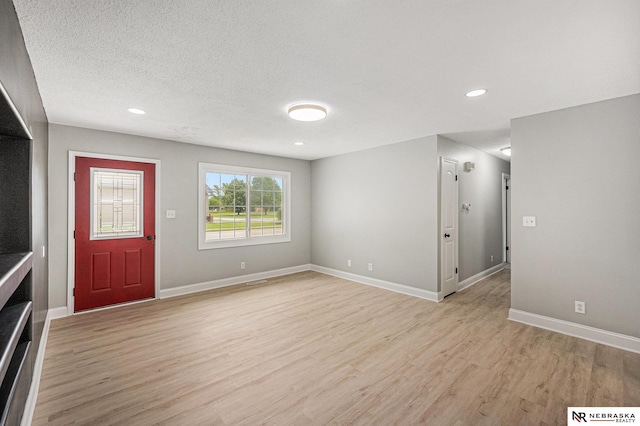 1409 Nelson Ln, Fremont, NE 68025 - entryway with light wood-style flooring, recessed lighting, and a textured ceiling
