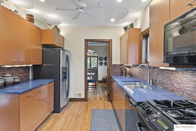 6024 Poppleton Ave, Omaha, NE 68106 - kitchen with stainless steel appliances, light wood finished floors, ceiling fan, backsplash, and recessed lighting