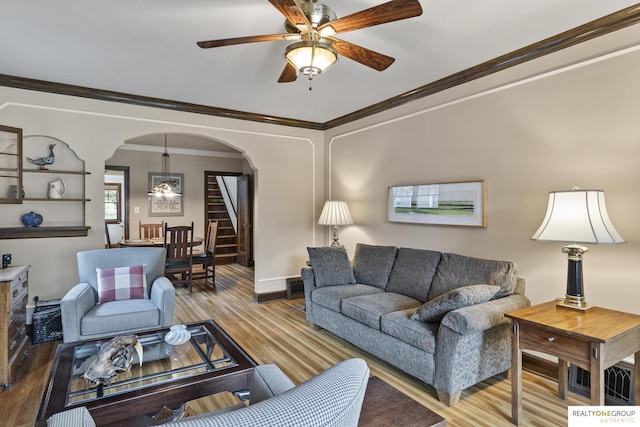 6024 Poppleton Ave, Omaha, NE 68106 - living area featuring stairs, arched walkways, wood finished floors, ceiling fan, and crown molding