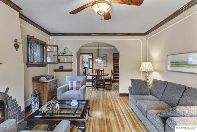 6024 Poppleton Ave, Omaha, NE 68106 - living room featuring arched walkways, wood finished floors, ceiling fan, and crown molding
