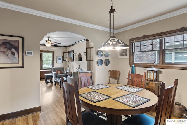 6024 Poppleton Ave, Omaha, NE 68106 - dining room featuring wood finished floors, arched walkways, ornamental molding, and ceiling fan