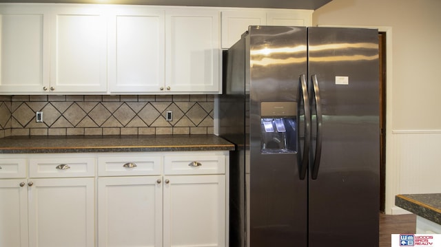 4211 S 36th St, Lincoln, NE 68506 - kitchen featuring stainless steel refrigerator with ice dispenser, dark countertops, white cabinets, and wainscoting