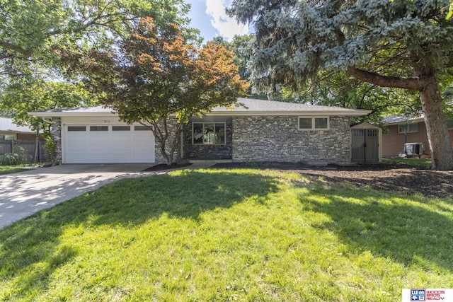 4211 S 36th St, Lincoln, NE 68506 - view of front of house featuring a garage, stone siding, and driveway