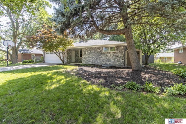 4211 S 36th St, Lincoln, NE 68506 - view of front facade featuring stone siding, a front yard, driveway, and a garage