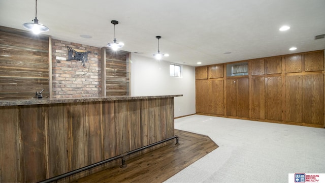 4211 S 36th St, Lincoln, NE 68506 - indoor wet bar with wood walls, hanging light fixtures, recessed lighting, and light colored carpet