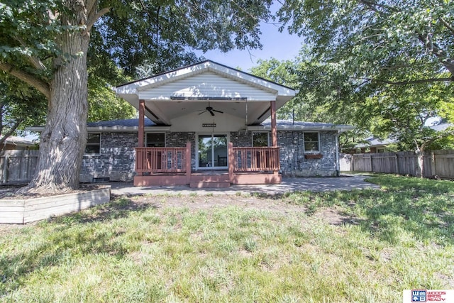 4211 S 36th St, Lincoln, NE 68506 - view of front of home with ceiling fan, a deck, brick siding, and a patio