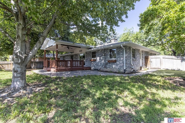 4211 S 36th St, Lincoln, NE 68506 - rear view of house featuring a chimney, a ceiling fan, and a wooden deck
