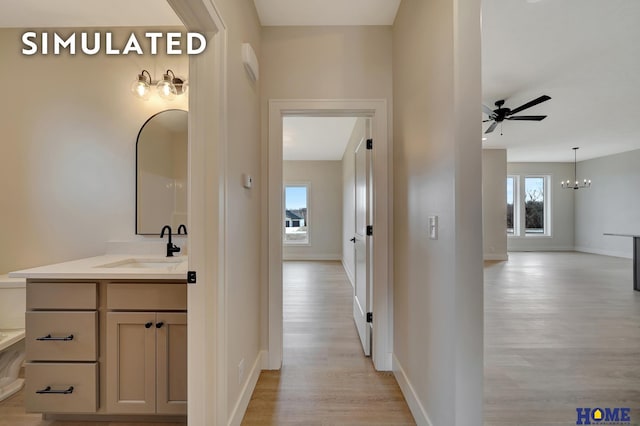 640 Eloise Ave, Lincoln, NE 68520 - corridor featuring light wood finished floors and a chandelier