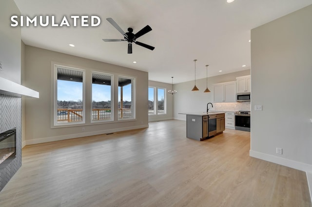 640 Eloise Ave, Lincoln, NE 68520 - unfurnished living room featuring a fireplace, recessed lighting, a ceiling fan, and light wood-style flooring