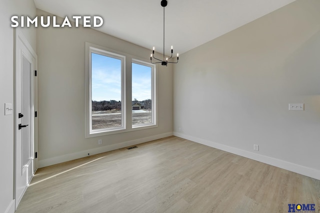 640 Eloise Ave, Lincoln, NE 68520 - unfurnished room featuring a chandelier and wood finished floors