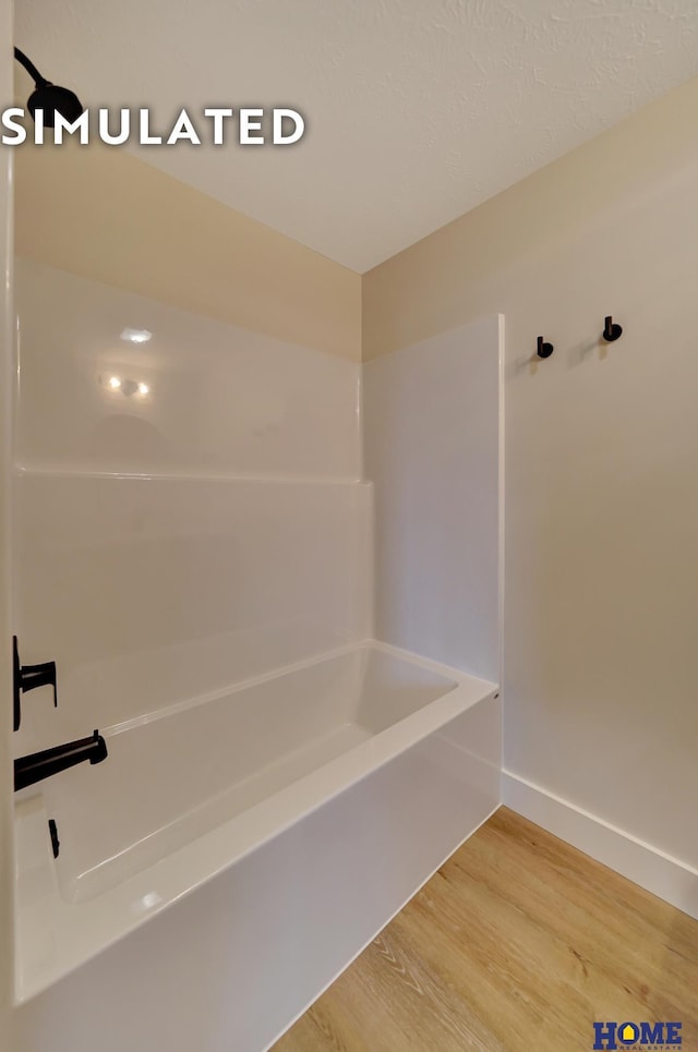 640 Eloise Ave, Lincoln, NE 68520 - bathroom featuring wood finished floors and bathing tub / shower combination