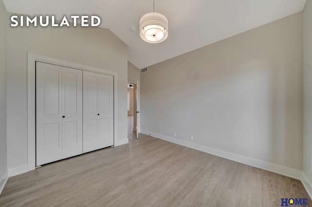 640 Eloise Ave, Lincoln, NE 68520 - unfurnished bedroom with wood finished floors, vaulted ceiling, and a closet