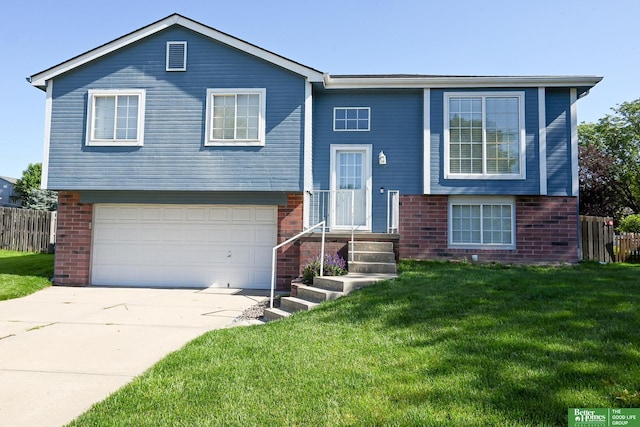 2412 Lewis And Clark Rd, Bellevue, NE 68123 - view of front facade with brick siding, a garage, and driveway