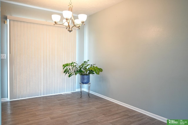 2412 Lewis And Clark Rd, Bellevue, NE 68123 - spare room featuring a chandelier and wood finished floors