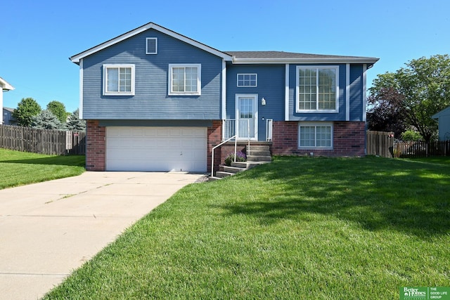 2412 Lewis And Clark Rd, Bellevue, NE 68123 - split foyer home with brick siding, a garage, and concrete driveway