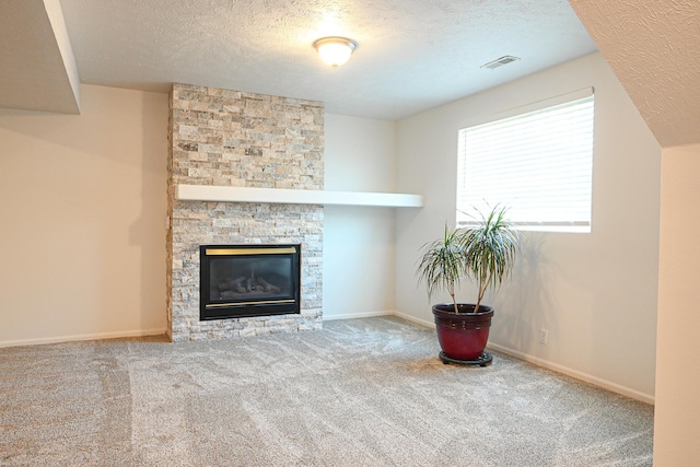 2412 Lewis And Clark Rd, Bellevue, NE 68123 - unfurnished living room featuring a textured ceiling, carpet, and a stone fireplace