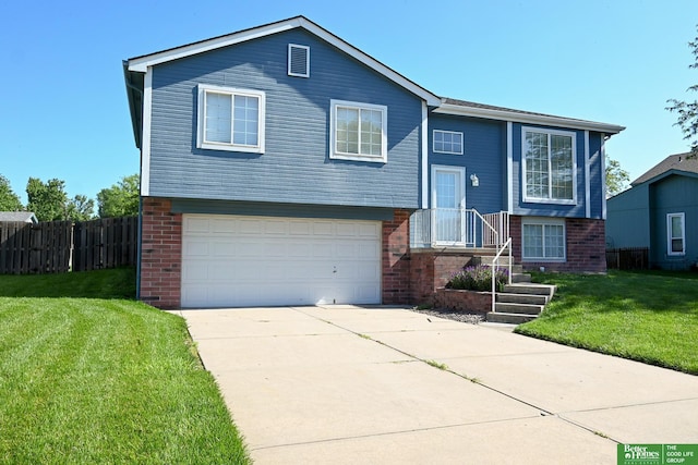 2412 Lewis And Clark Rd, Bellevue, NE 68123 - bi-level home featuring brick siding, an attached garage, and concrete driveway